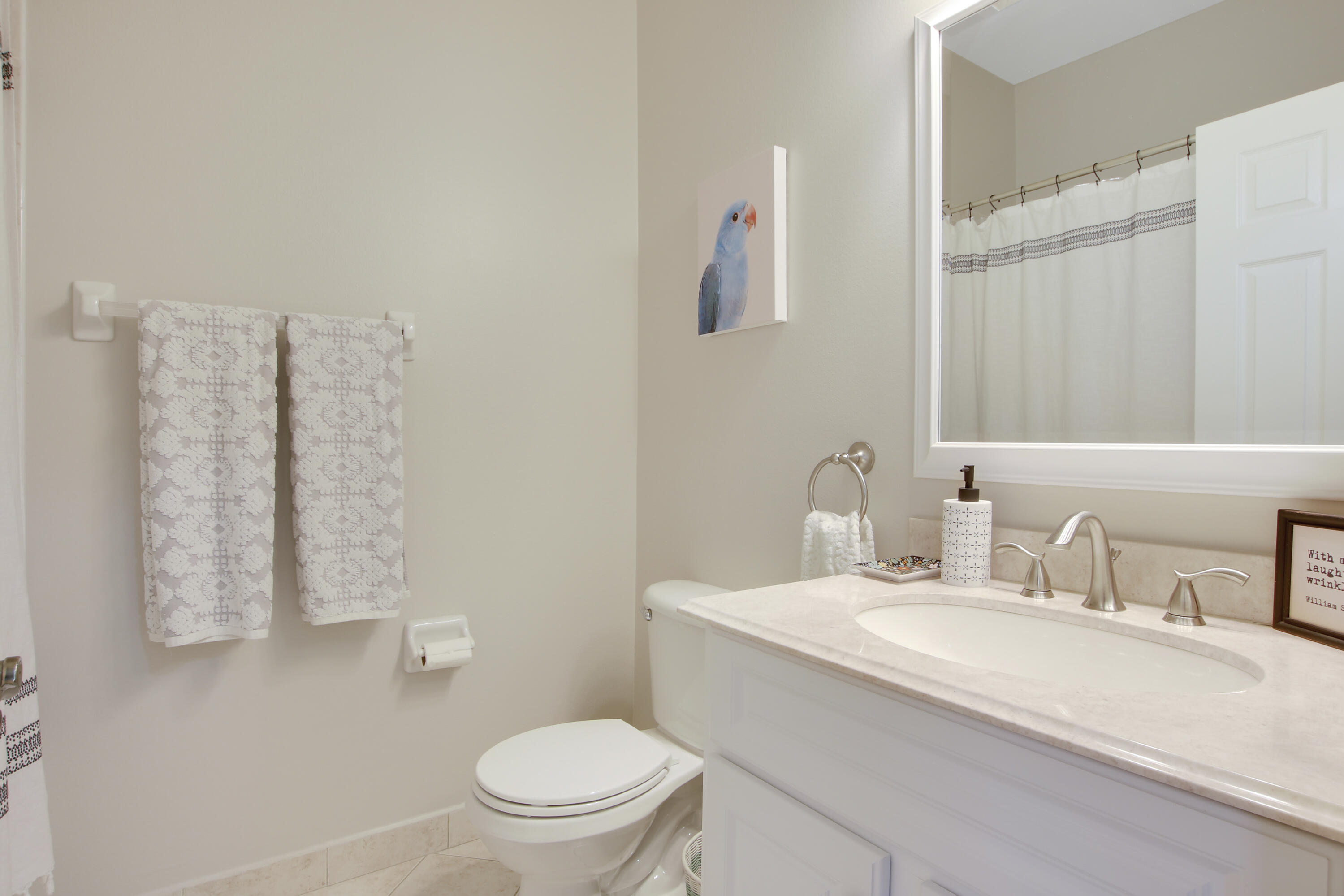 115 Lighthouse Circle, Unit D Tequesta, FL 33469 - Photo 18 of 28 a bathroom with a sink toilet and mirror