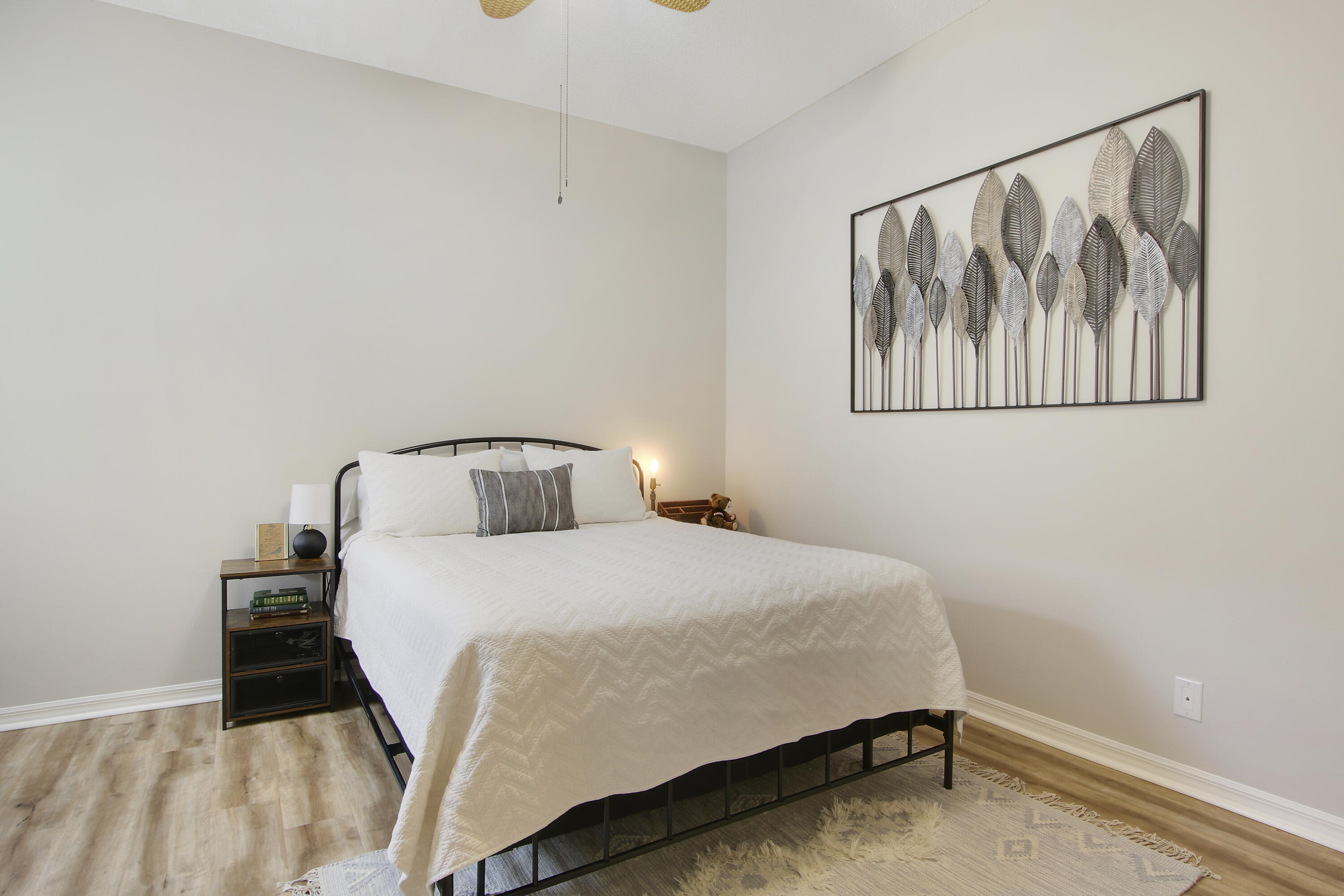 115 Lighthouse Circle, Unit D Tequesta, FL 33469 - Photo 19 of 28 a bedroom with a bed and wall painting