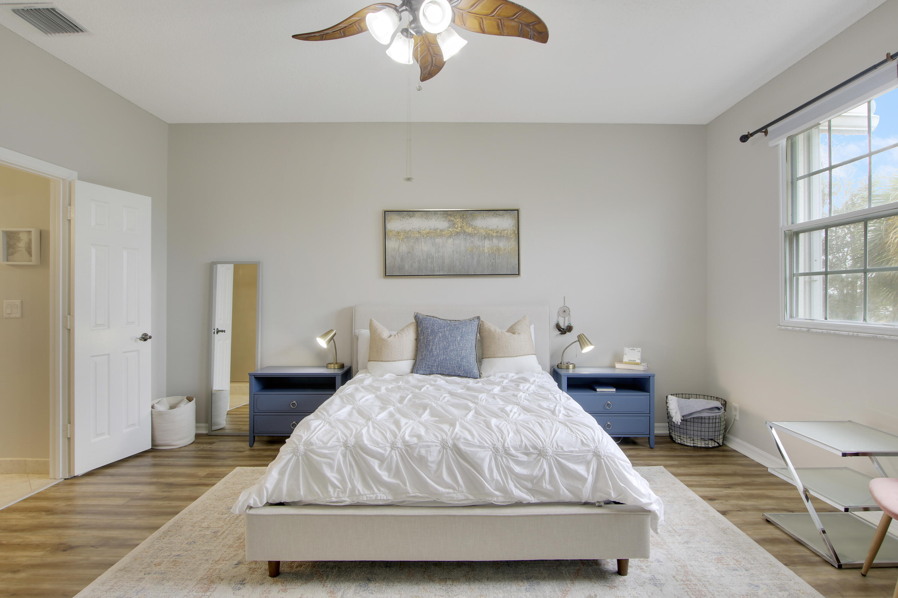 115 Lighthouse Circle, Unit D Tequesta, FL 33469 - Photo 21 of 28 a bedroom with a bed and a chandelier