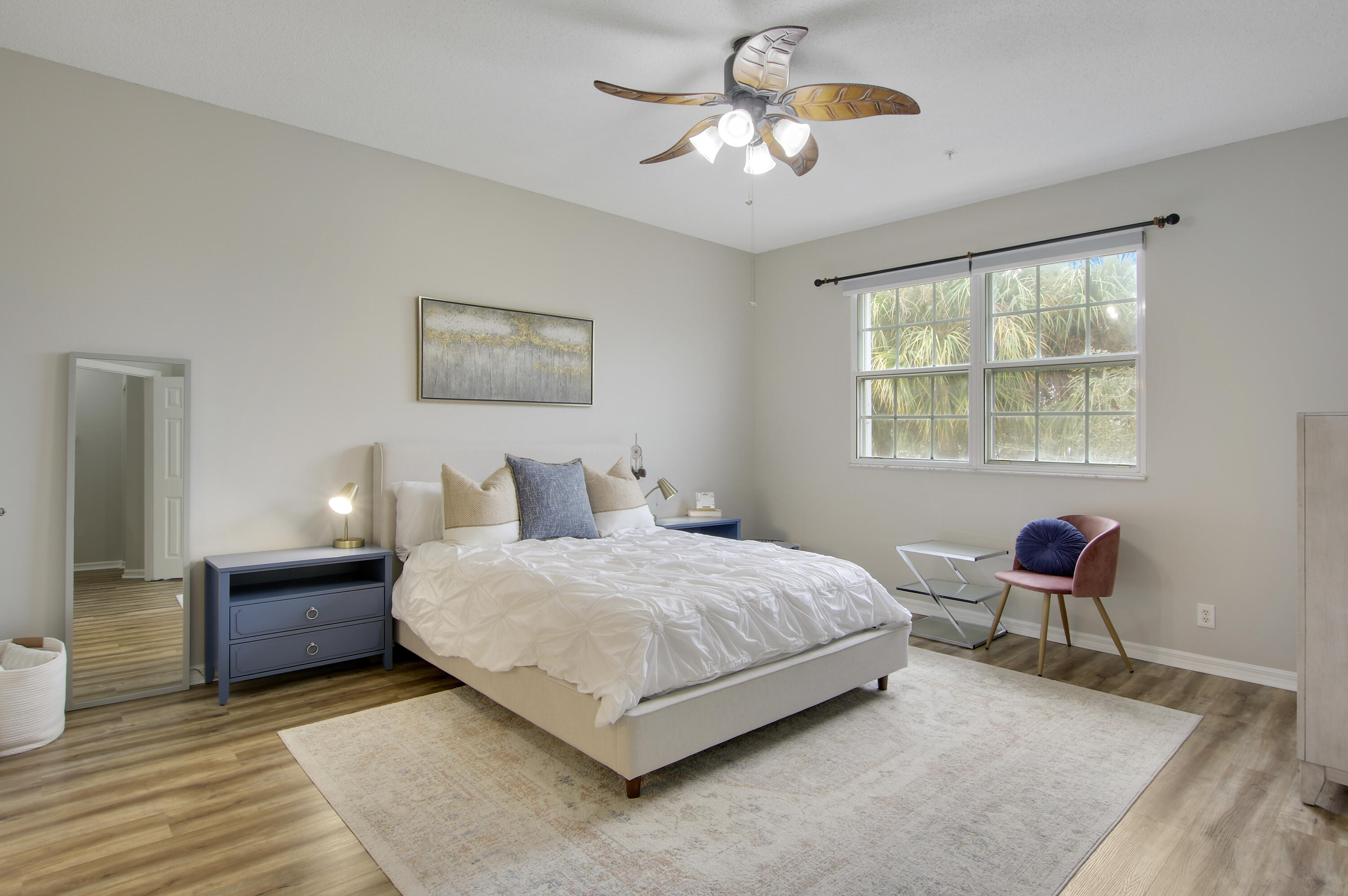 115 Lighthouse Circle, Unit D Tequesta, FL 33469 - Photo 24 of 28 a bedroom with a bed and a chandelier