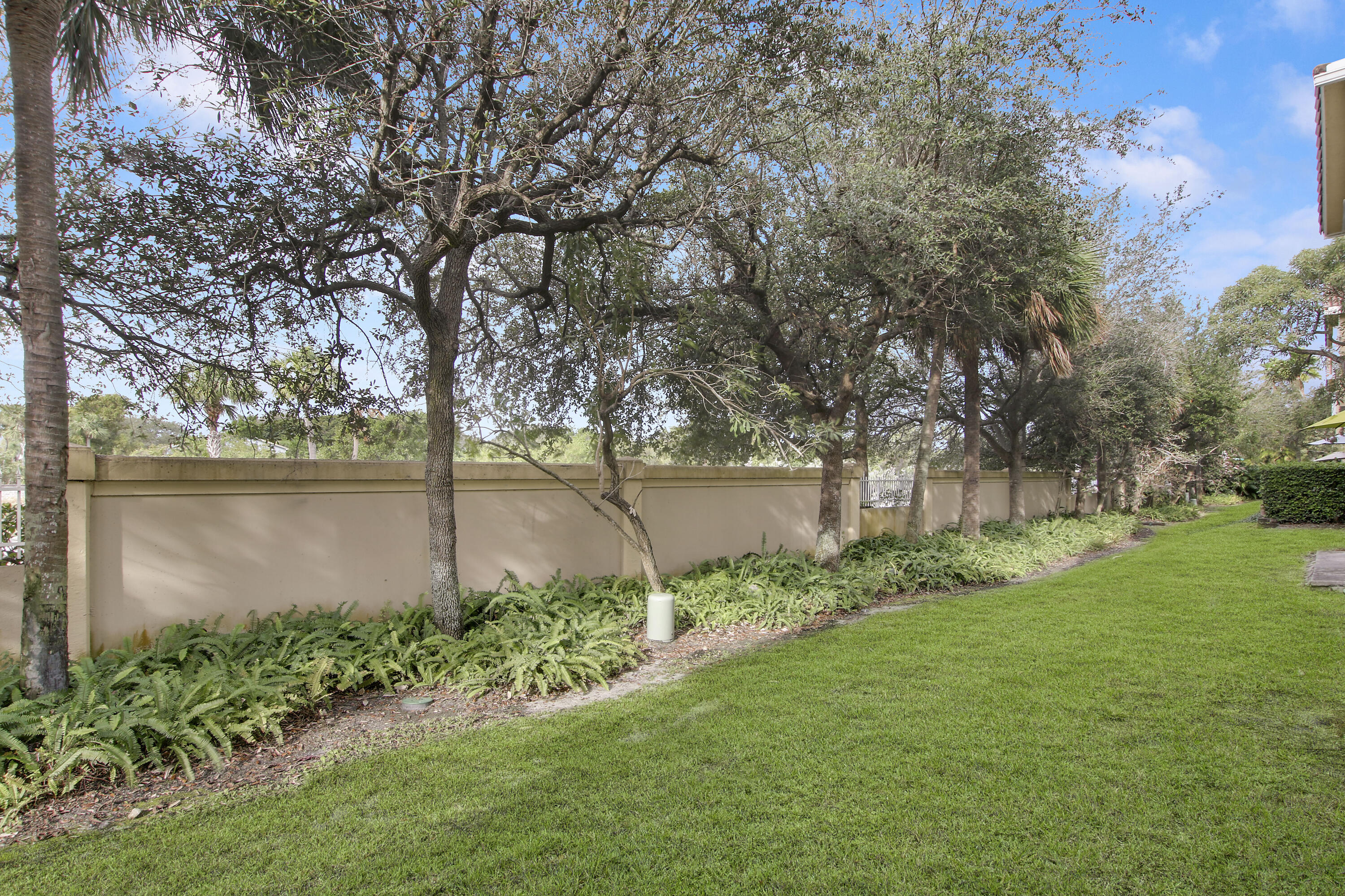 115 Lighthouse Circle, Unit D Tequesta, FL 33469 - Photo 27 of 28 a view of a lake from a yard