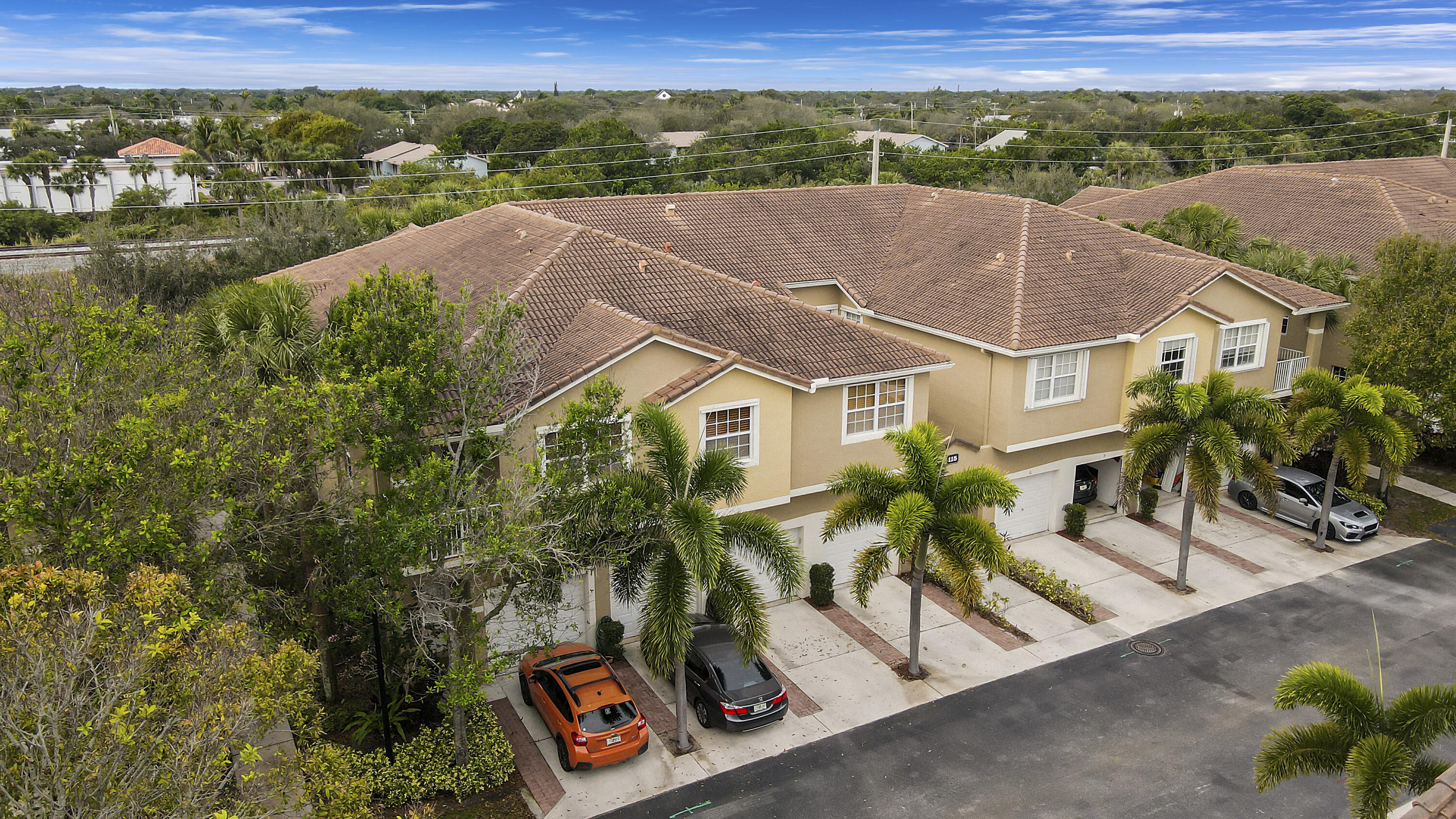 115 Lighthouse Circle, Unit D Tequesta, FL 33469 - Photo 3 of 28 an aerial view of a house with a yard