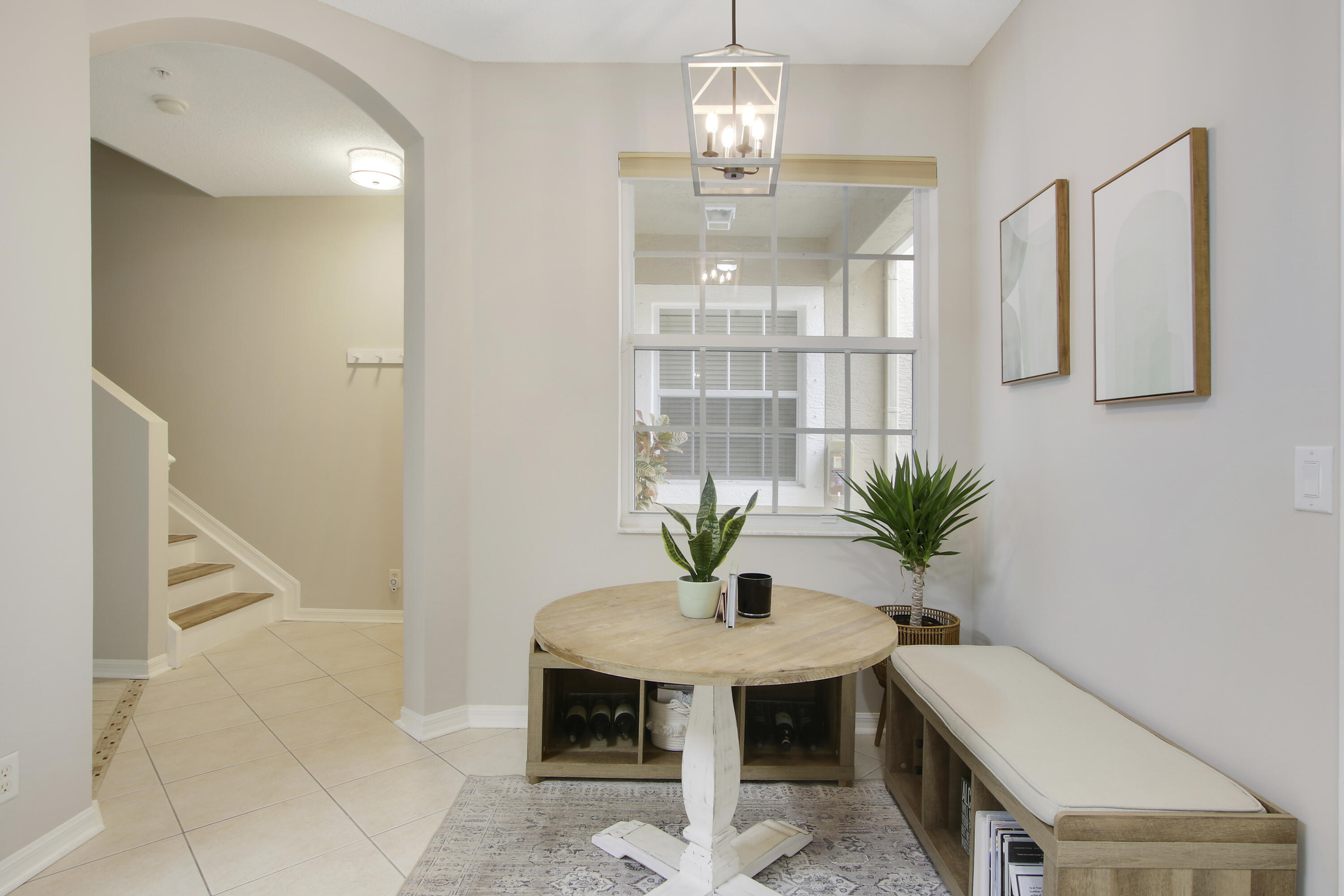 115 Lighthouse Circle, Unit D Tequesta, FL 33469 - Photo 5 of 28 a view of a room with a chandelier and wooden floor