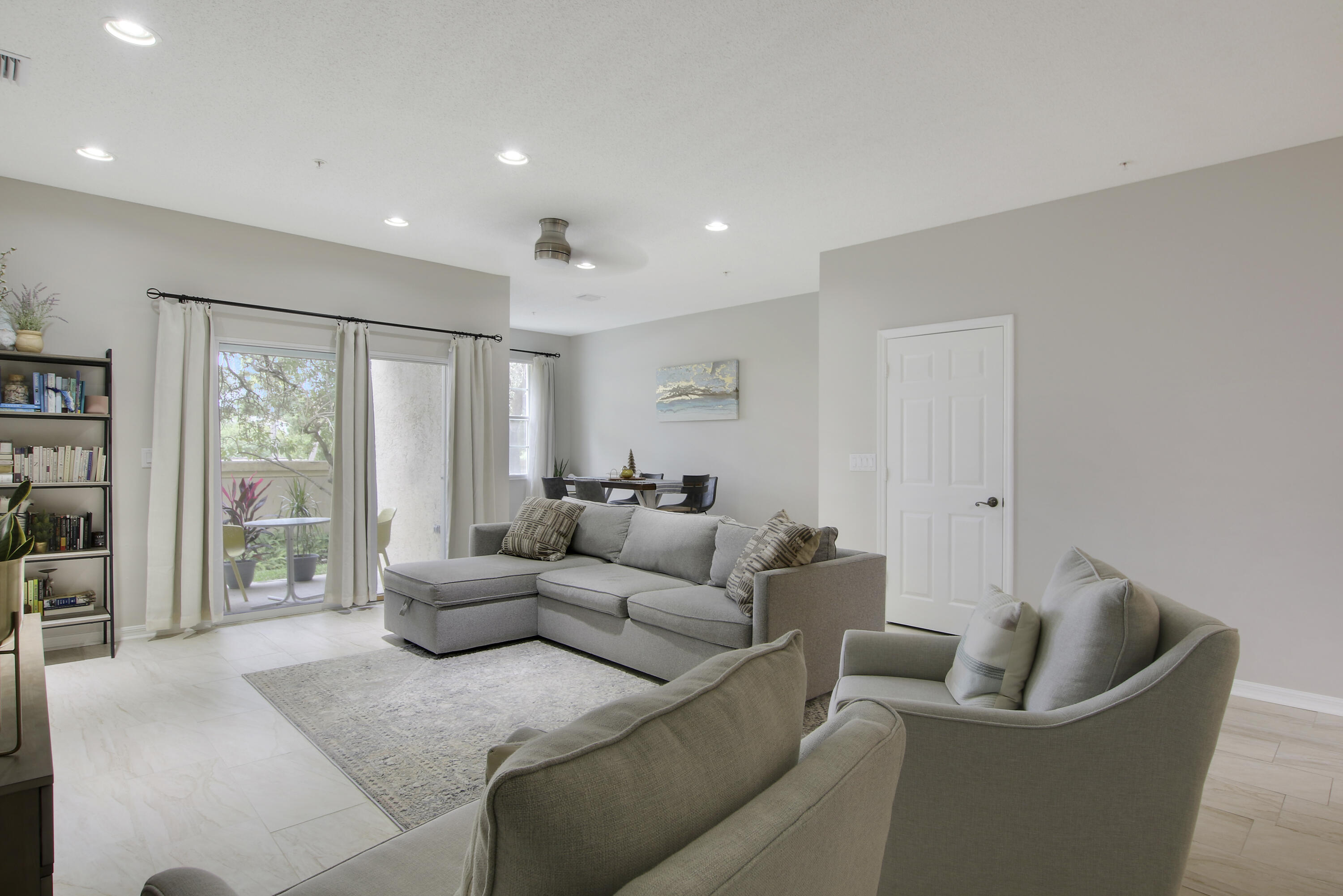 115 Lighthouse Circle, Unit D Tequesta, FL 33469 - Photo 9 of 28 a living room with furniture and a large window