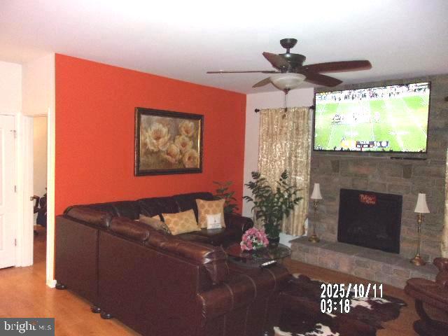 11612 Neon Road Fort Washington, MD 20744 - Photo 17 of 75 a living room with furniture a fireplace and a flat screen tv