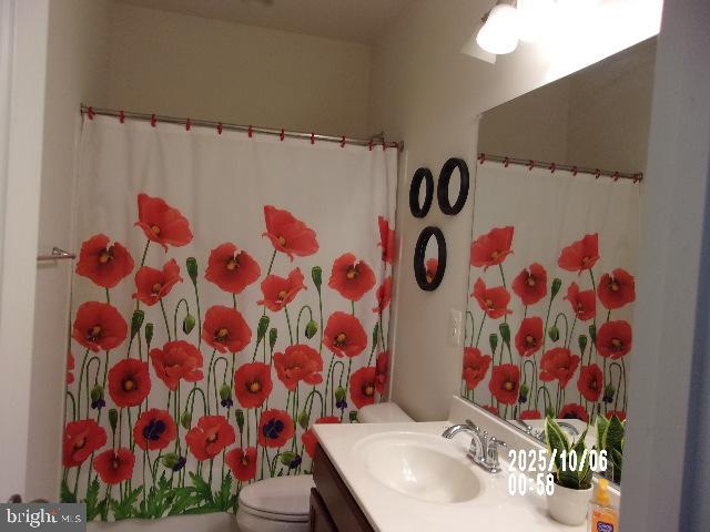 11612 Neon Road Fort Washington, MD 20744 - Photo 32 of 75 a bathroom with a sink and mirror with toilet