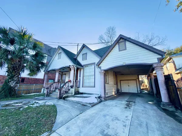 a view of a house with a patio and a yard