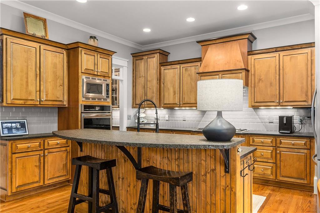 280 Sutherland Place Northeast Atlanta, GA 30307 - Photo 17 of 66 a kitchen with stainless steel appliances granite countertop a sink a stove and cabinets