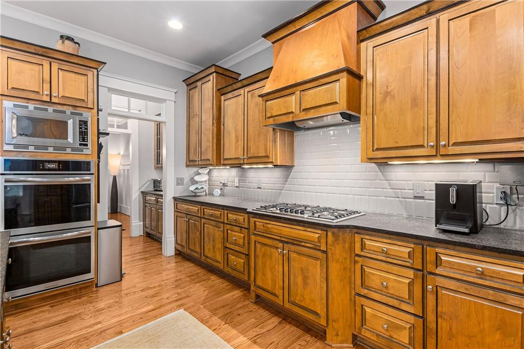 280 Sutherland Place Northeast Atlanta, GA 30307 - Photo 18 of 66 a kitchen with stainless steel appliances granite countertop a stove a sink and a microwave