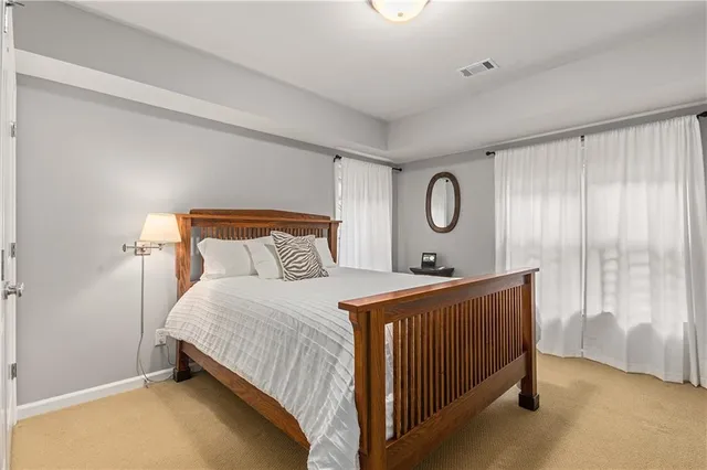a kitchen with a refrigerator and wooden floor