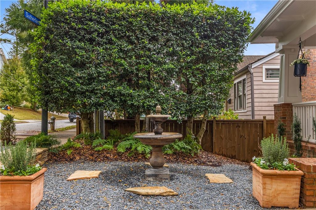 280 Sutherland Place Northeast Atlanta, GA 30307 - Photo 5 of 66 a backyard of a house with a fountain plants and large tree