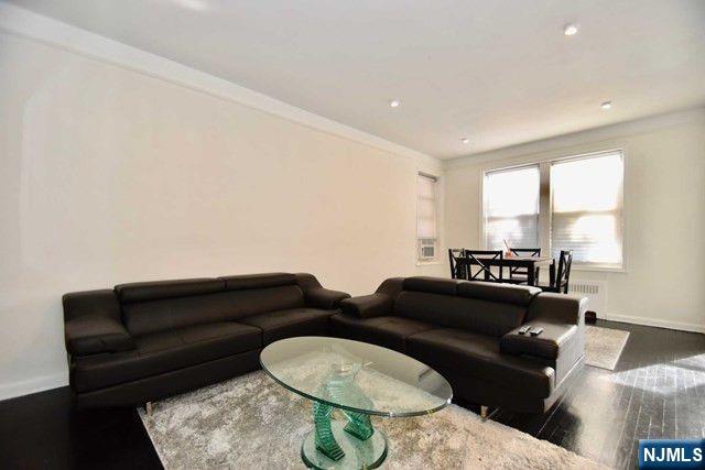 985 Teaneck Road, Unit 1J Teaneck, NJ 07666 - Photo 4 of 10 a living room with furniture and a large window
