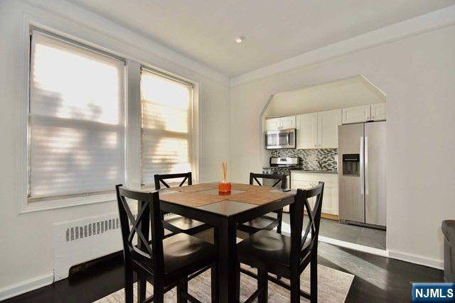 985 Teaneck Road, Unit 1J Teaneck, NJ 07666 - Photo 6 of 10 a dining room with furniture and window