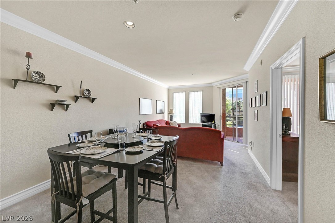 220 East Flamingo Road, Unit 305 Las Vegas, NV 89169 - Photo 6 of 26 An inviting open-plan living and dining area with clean lines and abundant natural light.