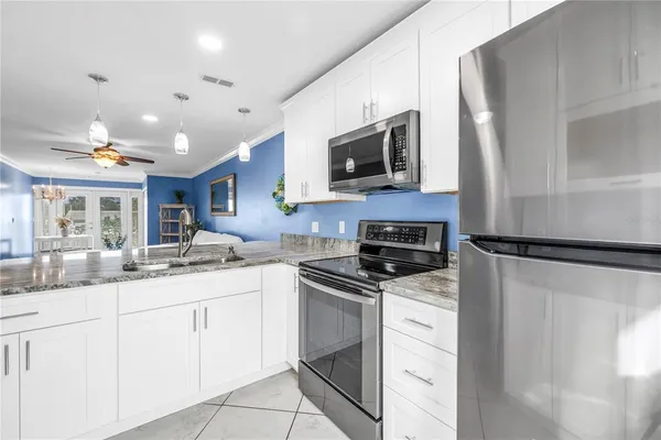 a kitchen with a sink stainless steel appliances and cabinets