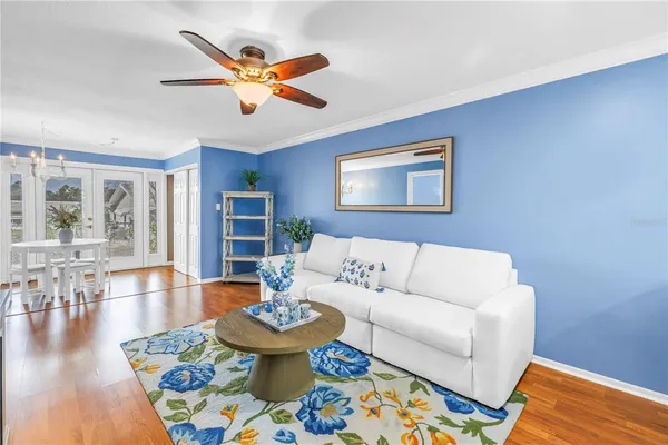 a living room with furniture and wooden floor