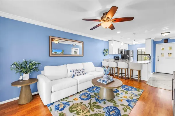 a living room with furniture and a chandelier