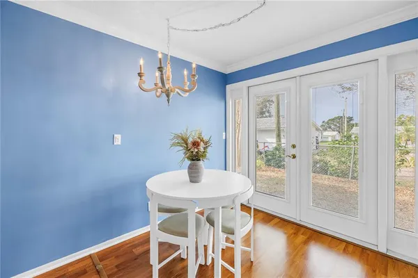 a view of a dining room with furniture and a window