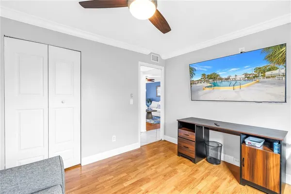 a bedroom with a bed and a painting on the wall