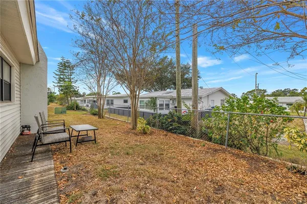 a view of a house with backyard and sitting area