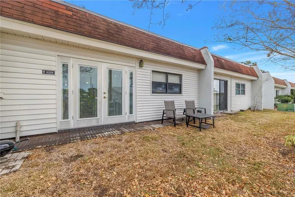 a backyard of a house with table and chairs