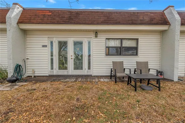 a backyard of a house with table and chairs