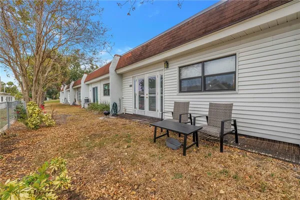 a view of a house with backyard and sitting area
