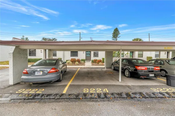 a view of a cars is parked in front of a house