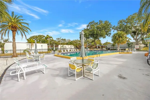 a view of a swimming pool with outdoor seating and a garden