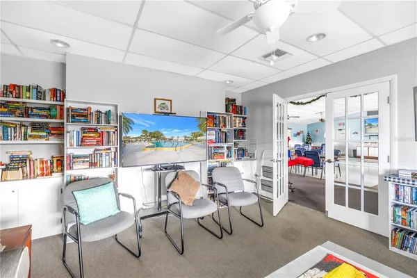 a living room with lots of furniture and a book shelf
