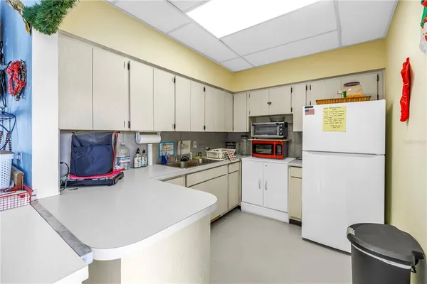a kitchen with refrigerator a stove a sink and a refrigerator