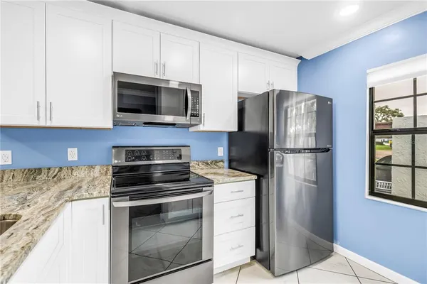 a kitchen with a refrigerator stove and microwave