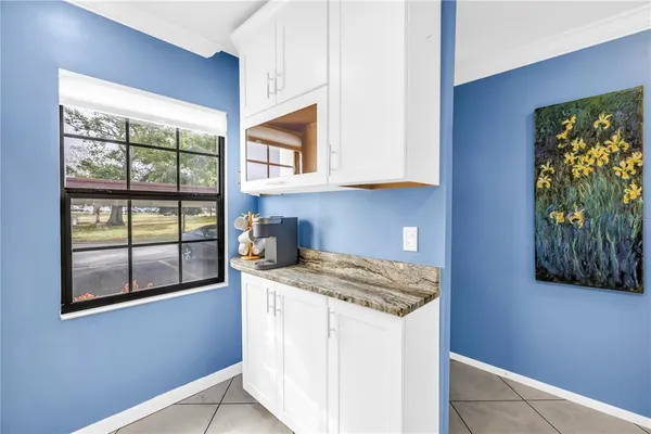 a kitchen with a stove a sink and a window