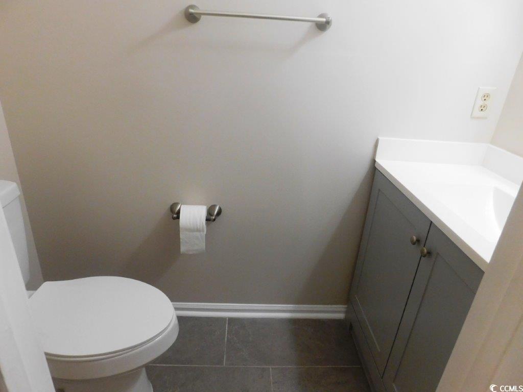 1025 Carolina Road, Unit FF3 Conway, SC 29526 - Photo 14 of 16 Bathroom featuring vanity, toilet, and tile patter