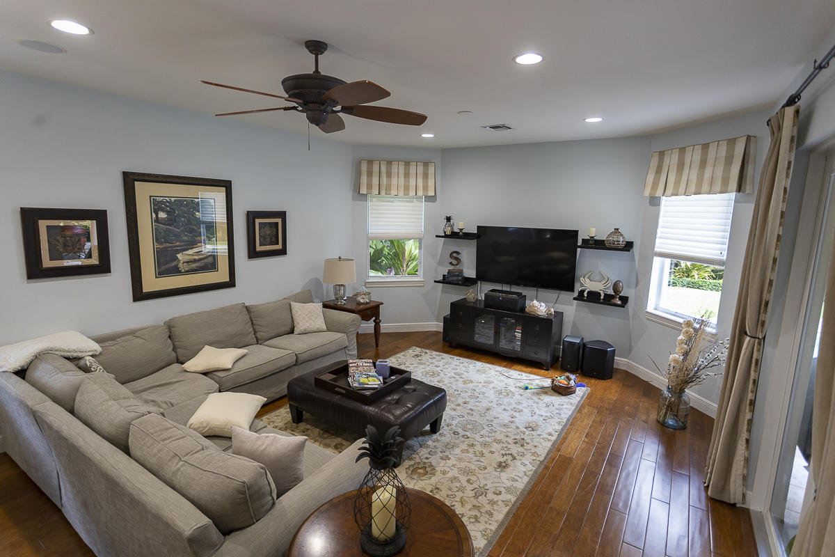 1301 Southwest 16th Street Boca Raton, FL 33486 - Photo 15 of 57 a living room with furniture a window and a flat screen tv