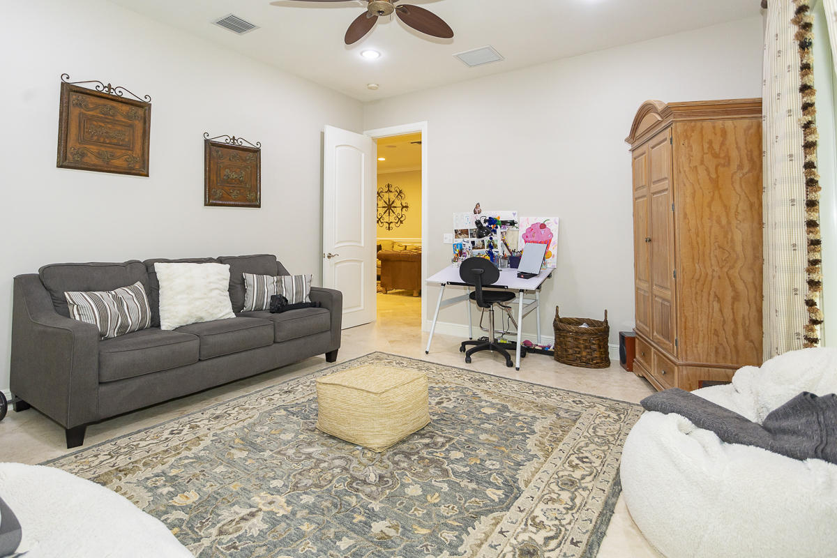 1301 Southwest 16th Street Boca Raton, FL 33486 - Photo 26 of 57 a living room with furniture a rug and a chandelier