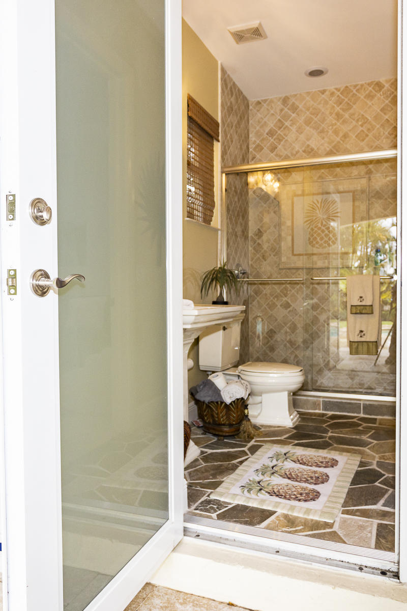 1301 Southwest 16th Street Boca Raton, FL 33486 - Photo 27 of 57 a bathroom with a toilet a sink and shower