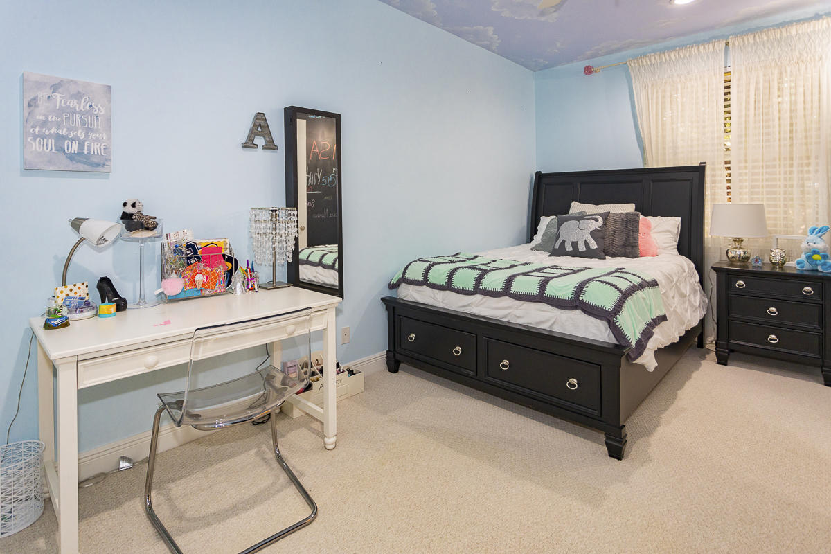 1301 Southwest 16th Street Boca Raton, FL 33486 - Photo 29 of 57 a bedroom with a bed and a table in it