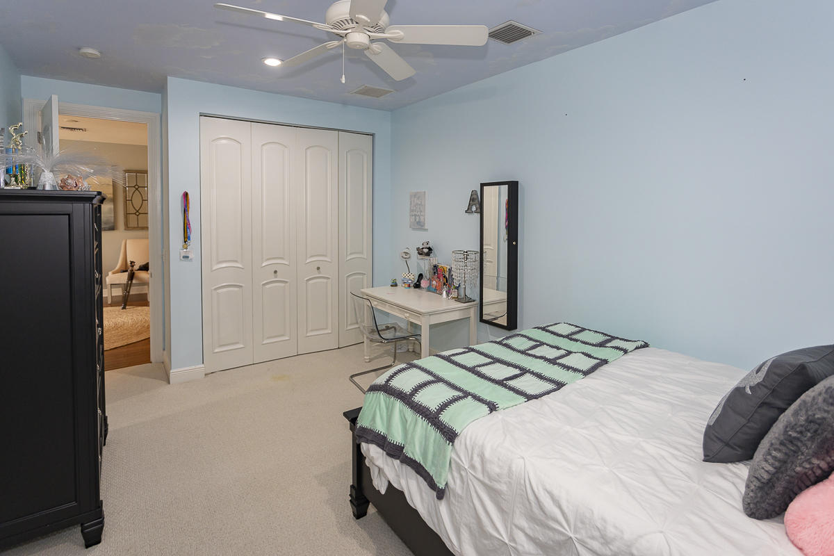 1301 Southwest 16th Street Boca Raton, FL 33486 - Photo 31 of 57 a bedroom with a bed and a chandelier