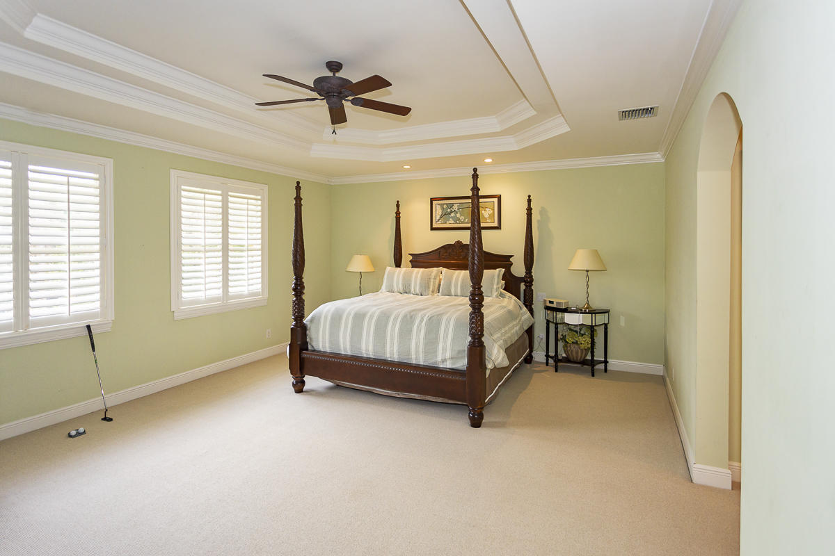 1301 Southwest 16th Street Boca Raton, FL 33486 - Photo 38 of 57 a bedroom with a bed and a chandelier