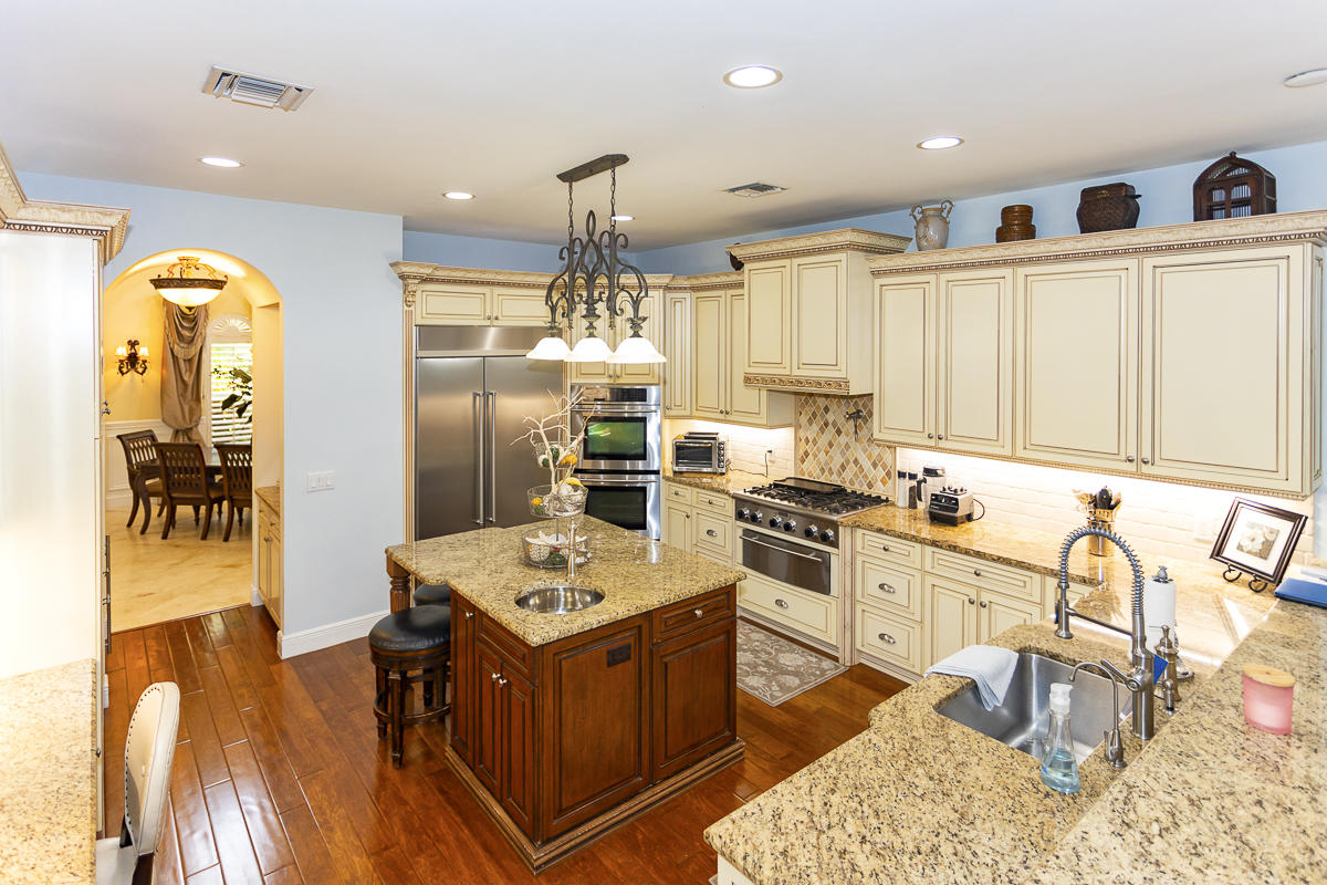 1301 Southwest 16th Street Boca Raton, FL 33486 - Photo 4 of 57 a kitchen with stainless steel appliances granite countertop a sink stove and refrigerator