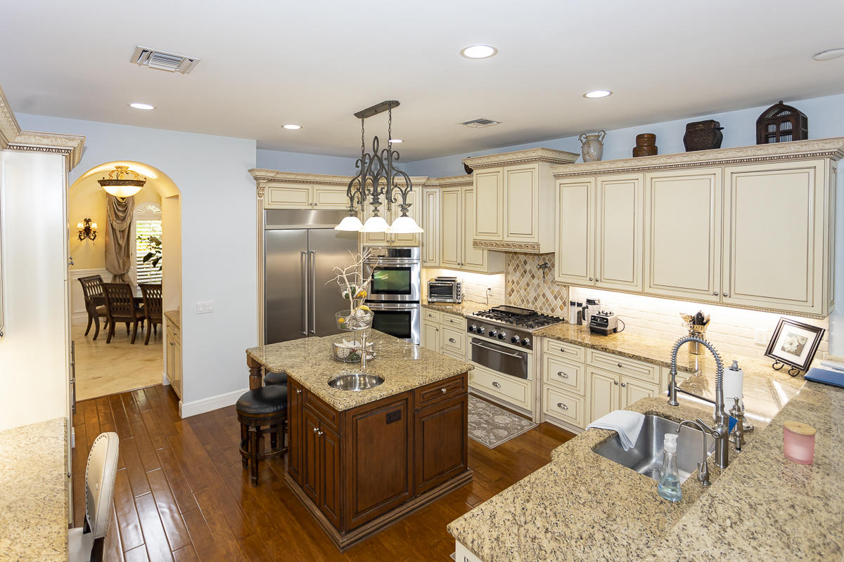 1301 Southwest 16th Street Boca Raton, FL 33486 - Photo 5 of 57 a kitchen with stainless steel appliances granite countertop a sink stove and refrigerator