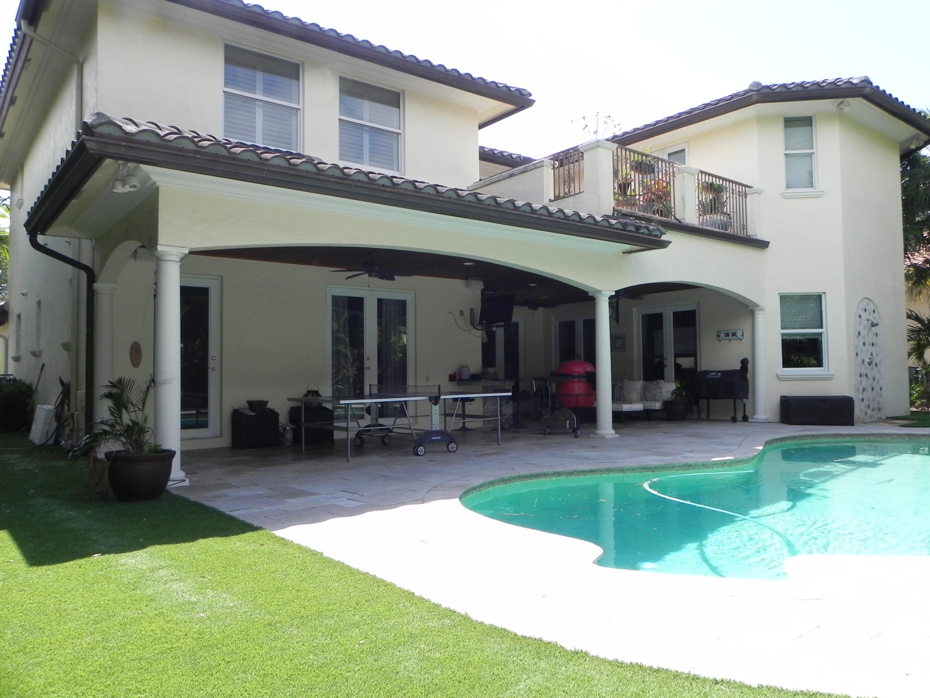 1301 Southwest 16th Street Boca Raton, FL 33486 - Photo 51 of 57 a view of a house with a patio and a yard