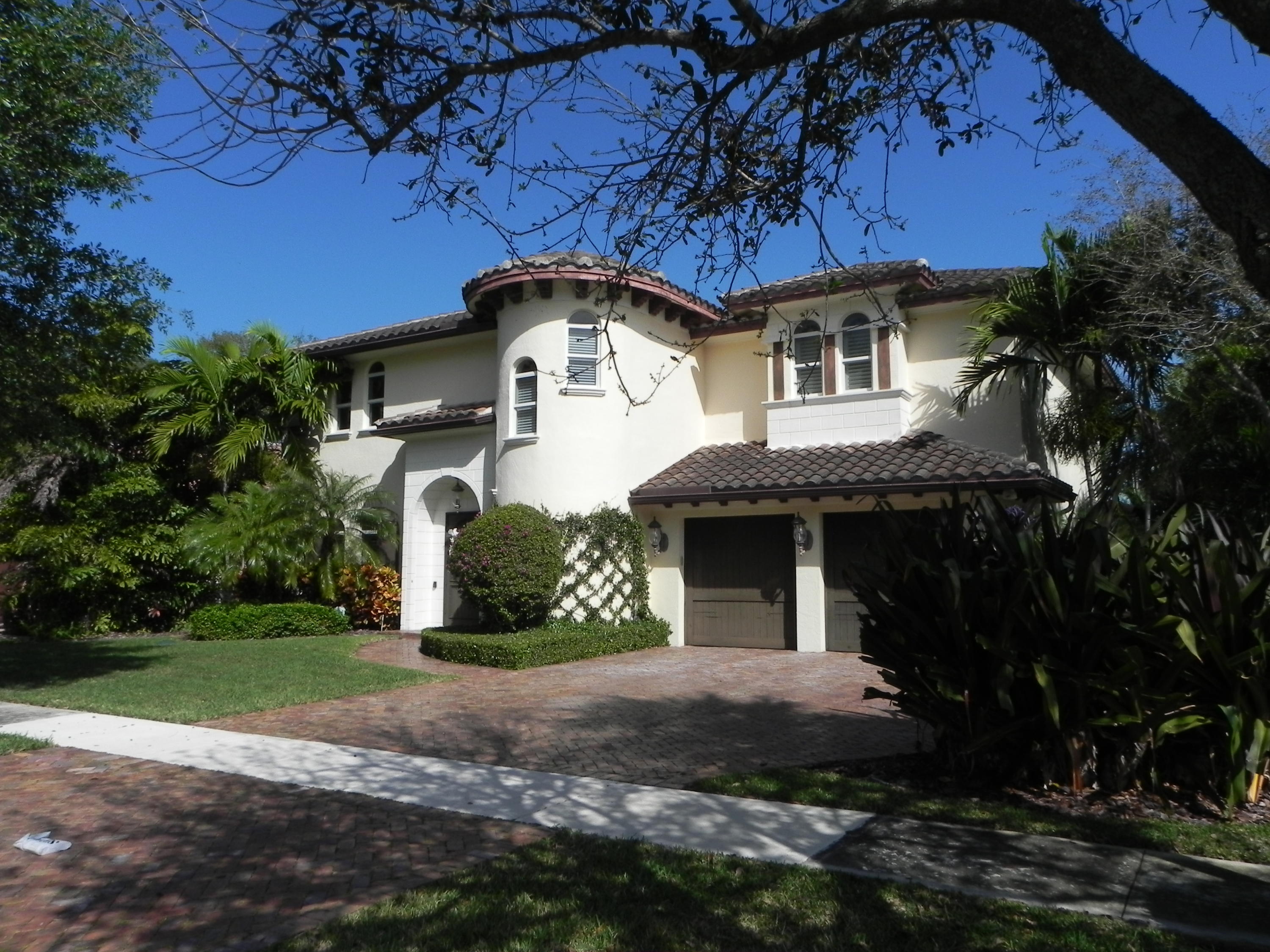 1301 Southwest 16th Street Boca Raton, FL 33486 - Photo 56 of 57 a front view of a house with a yard and garage