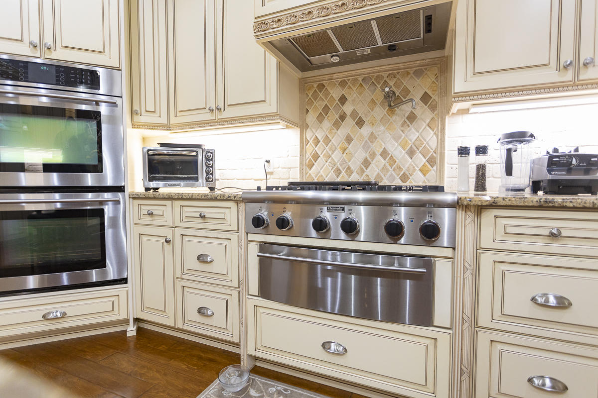1301 Southwest 16th Street Boca Raton, FL 33486 - Photo 6 of 57 a kitchen with granite countertop a stove and a microwave oven