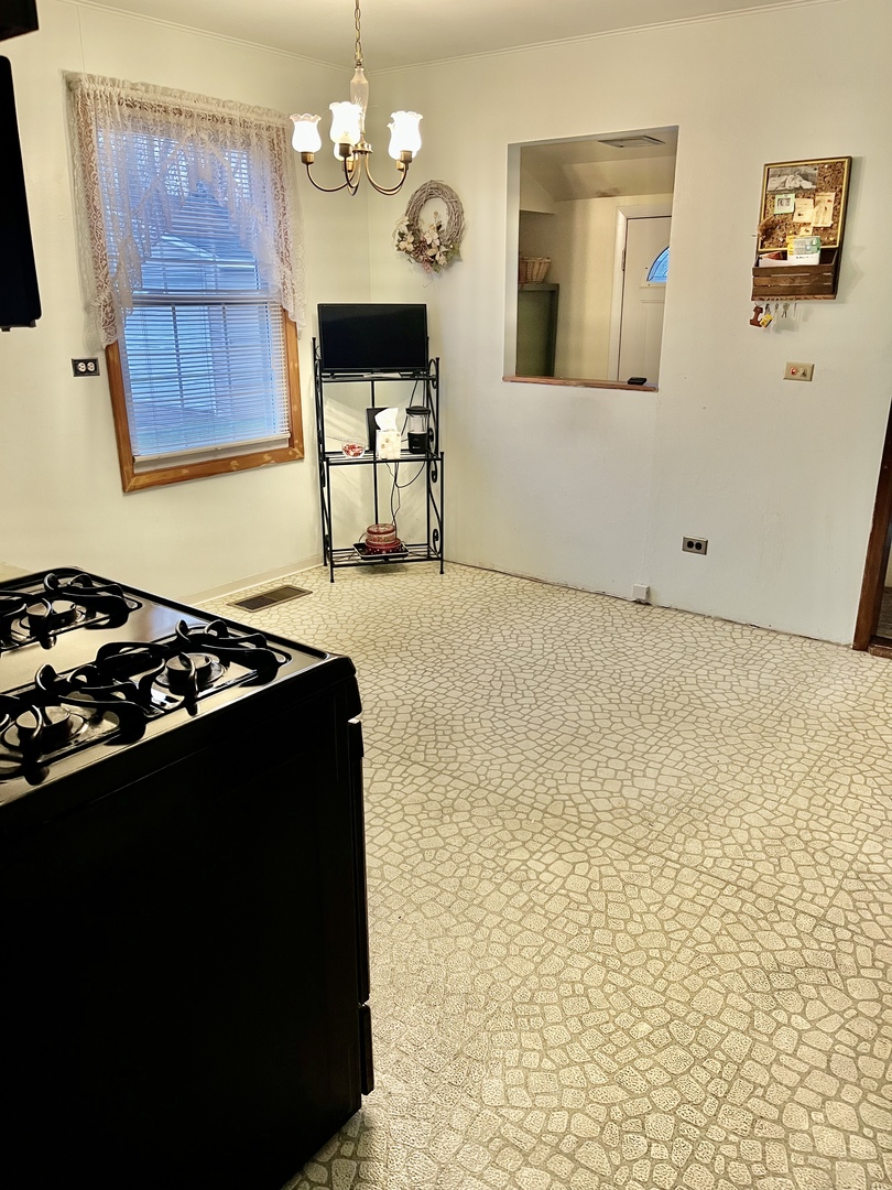 2601 George Street Rolling Meadows, IL 60008 - Photo 4 of 12 a kitchen with granite countertop a stove and a refrigerator