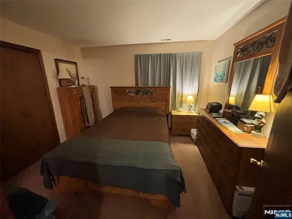 a bedroom with a bed and a mirror