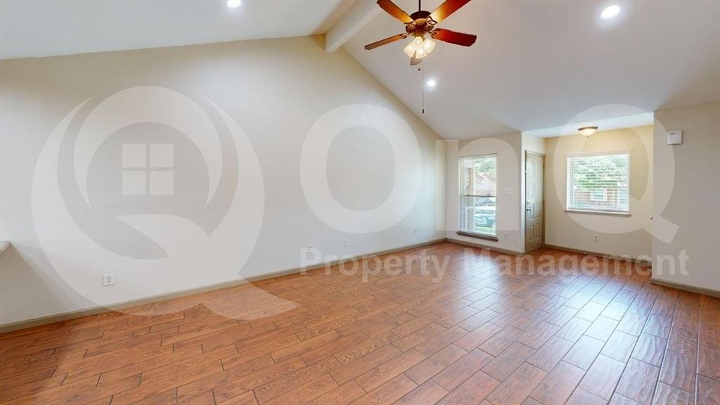 3000 Timothy Lane Euless, TX 76039 - Photo 6 of 19 Spacious room featuring wood-finish flooring, vaulted ceiling, and recessed lighting
