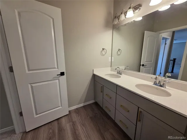 a bathroom with a double vanity sink and a mirror