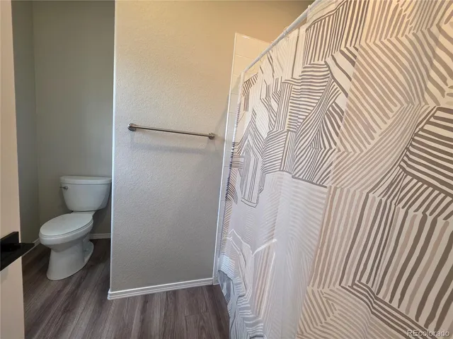 a bathroom with a toilet and a shower